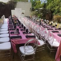 Pink-dressed banquet tables with a floral centrepiece