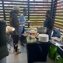 Guests serving themselves at an indoor buffet